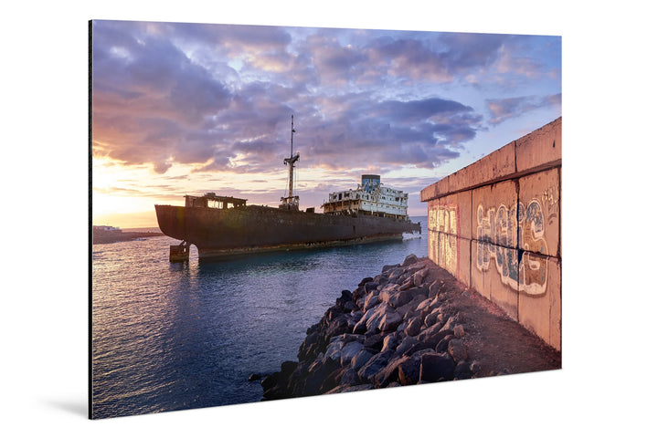 Abandoned ship floating near rocky shore under dramatic blue hour sky with clouds at dusk. - 45 x 30cm / Photo hinter Acrylglas / Unframed