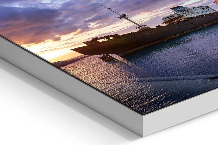 Sunset view of a ghost ship silhouette on calm sea with dramatic clouds and orange-purple sky. - 45 x 30cm / Photo hinter Acrylglas / Unframed