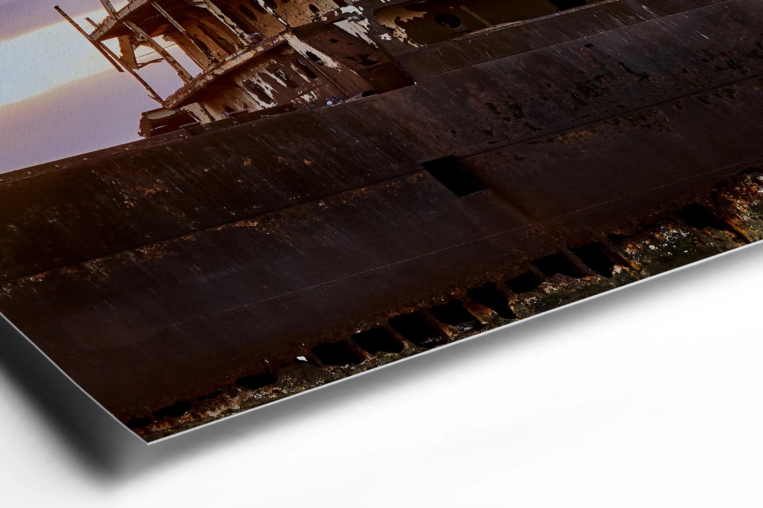 Rusty hull of a large abandoned ship with weathered metal plates and jagged edges against a dark background. - 45 x 30cm / Photo hinter Acrylglas / Unframed