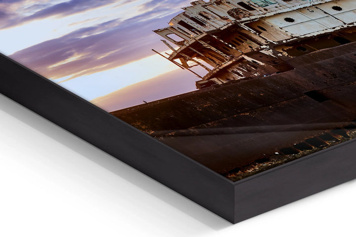 Close-up of a framed photo print showing part of a rusty shipwreck under a cloudy blue and pink sunset sky. - 45 x 30cm / Photo hinter Acrylglas / Unframed