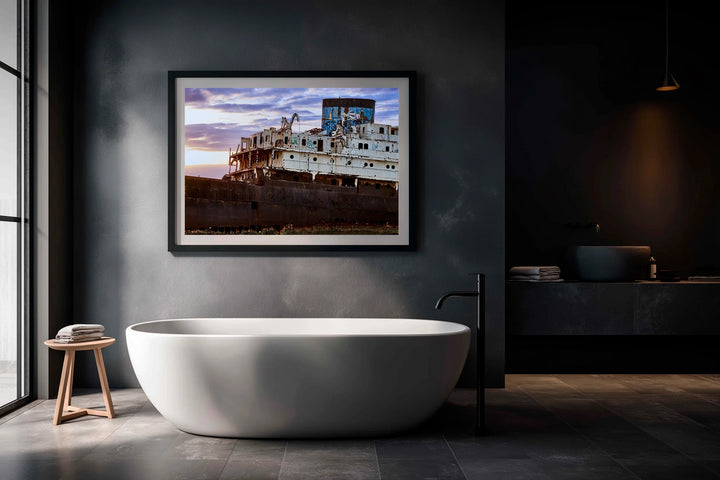 Framed photo of an abandoned ship at blue hour with clouds over the sea, displayed above a modern white bathtub in a dark. - 45 x 30cm / Photo hinter Acrylglas / Unframed