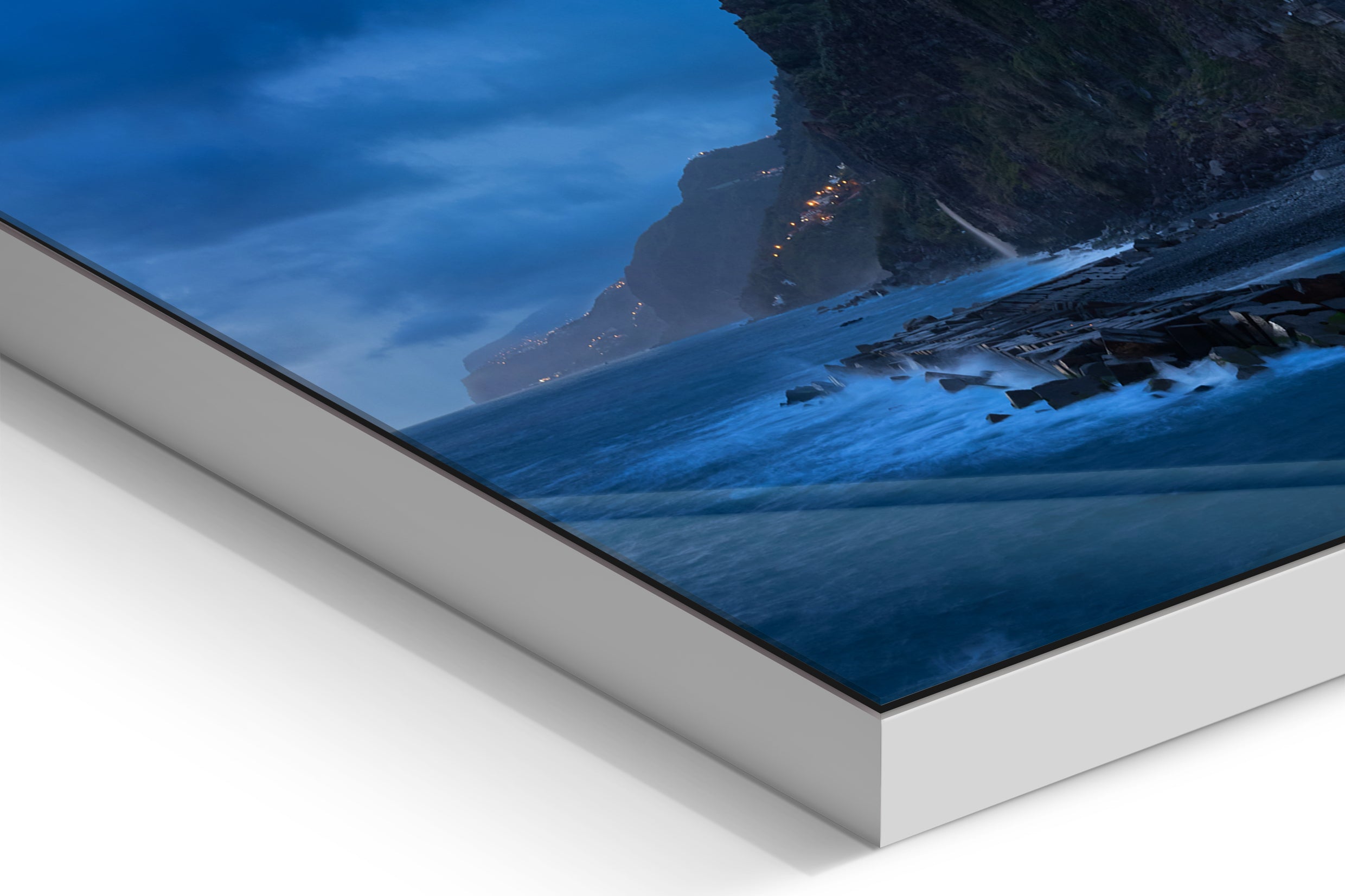 Coastal cliff and rocky shoreline under a moody blue hour sky with clouds over the sea. - 90 x 38 cm / Photo hinter Acrylglas / Unframed